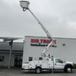 A white bucket truck from the inventory of Big Trucks & Equipment Sales