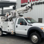A white bucket truck with a crane extender