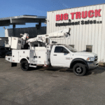 A white Dodge Ram 5500 Altec bucket truck