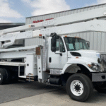 A bucket truck parked outside Big Truck & Equipment Sales