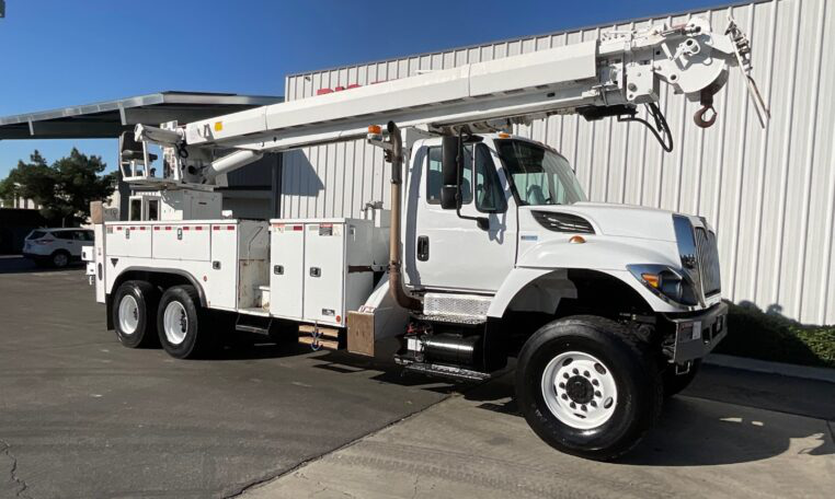 A 2015 International 7400 6x6 Altec D4065B-TR Digger Derrick Truck by Big Truck & Equipment Sales