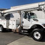 A 2015 International 7400 6x6 Altec D4065B-TR Digger Derrick Truck