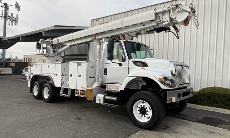 A 2013 International 7400 6x6 Altec D4065B-TR Digger Derrick Truck by Big Truck & Equipment Sales