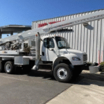 Digger derrick truck in action on a utility site