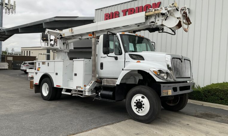A 2013 International 7300 4x4 Altec DM47B-TR Digger Derrick Truckby Big Truck & Equipment Sales