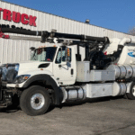 Worker operating a vacuum truck with safety features in place