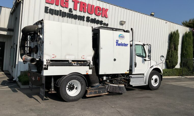 Second 2017 Freightliner M2 Schwarze A8 Twister vacuum sweeper clearing debris.