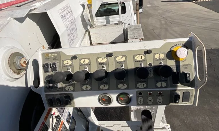 operation buttons on a 2015 International 7400 6x6 Altec D4065B-TR Digger Derrick Truck