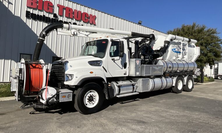 2016 Freightliner 114SD Vactor 2100 Plus hydro excavation vacuum truck clearing a storm drain.